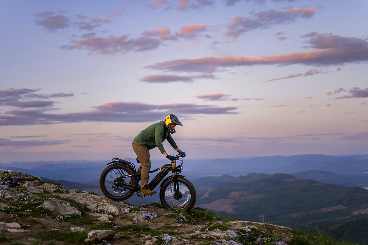Burchda HC26 on a mountain ridge at dusk — dual-motor AWD in real terrain