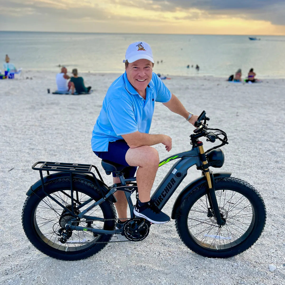 An American cycling enthusiast riding a Burchda RX80 on sandy terrain