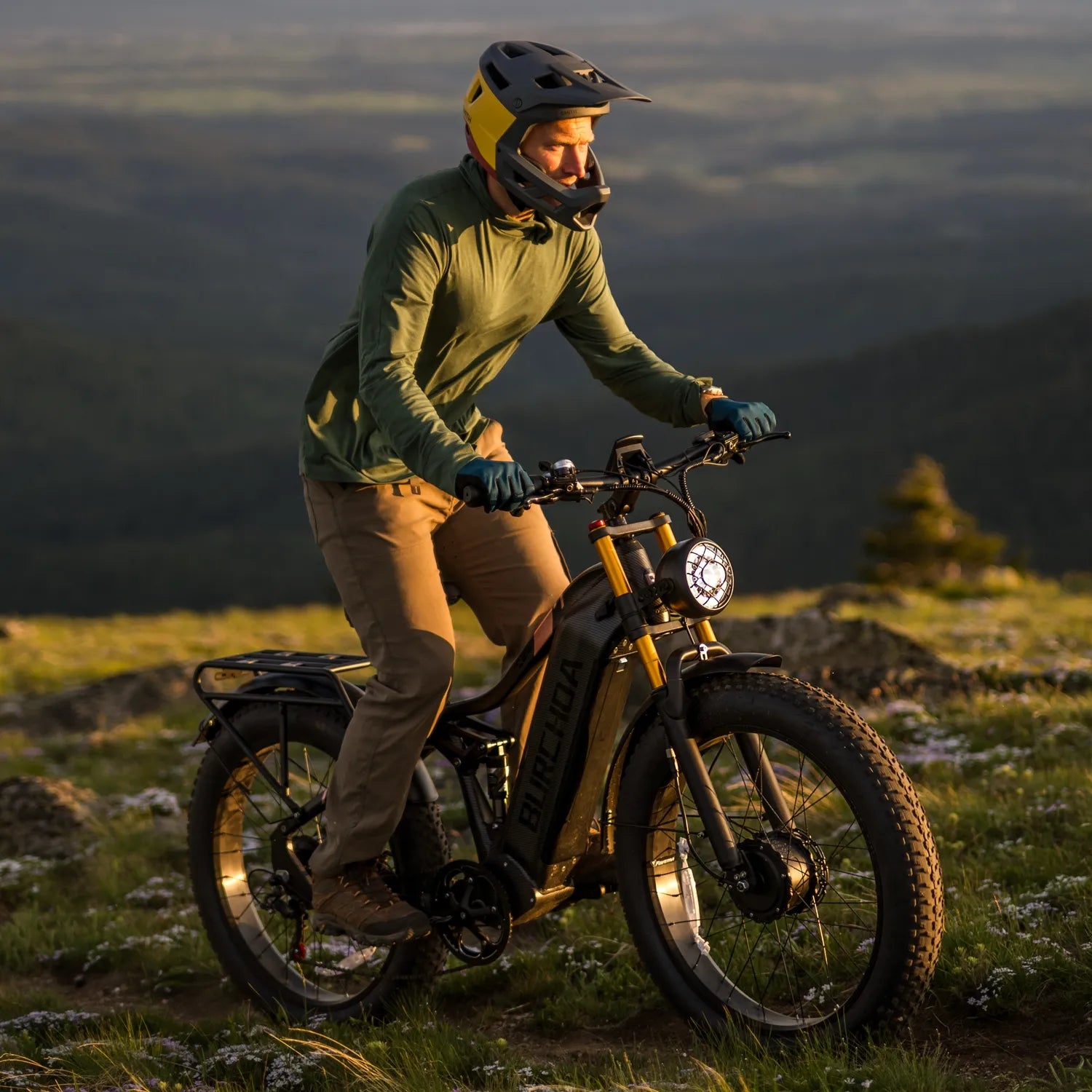 A man rides an HC26 AWD off-road electric bike up a hillside
