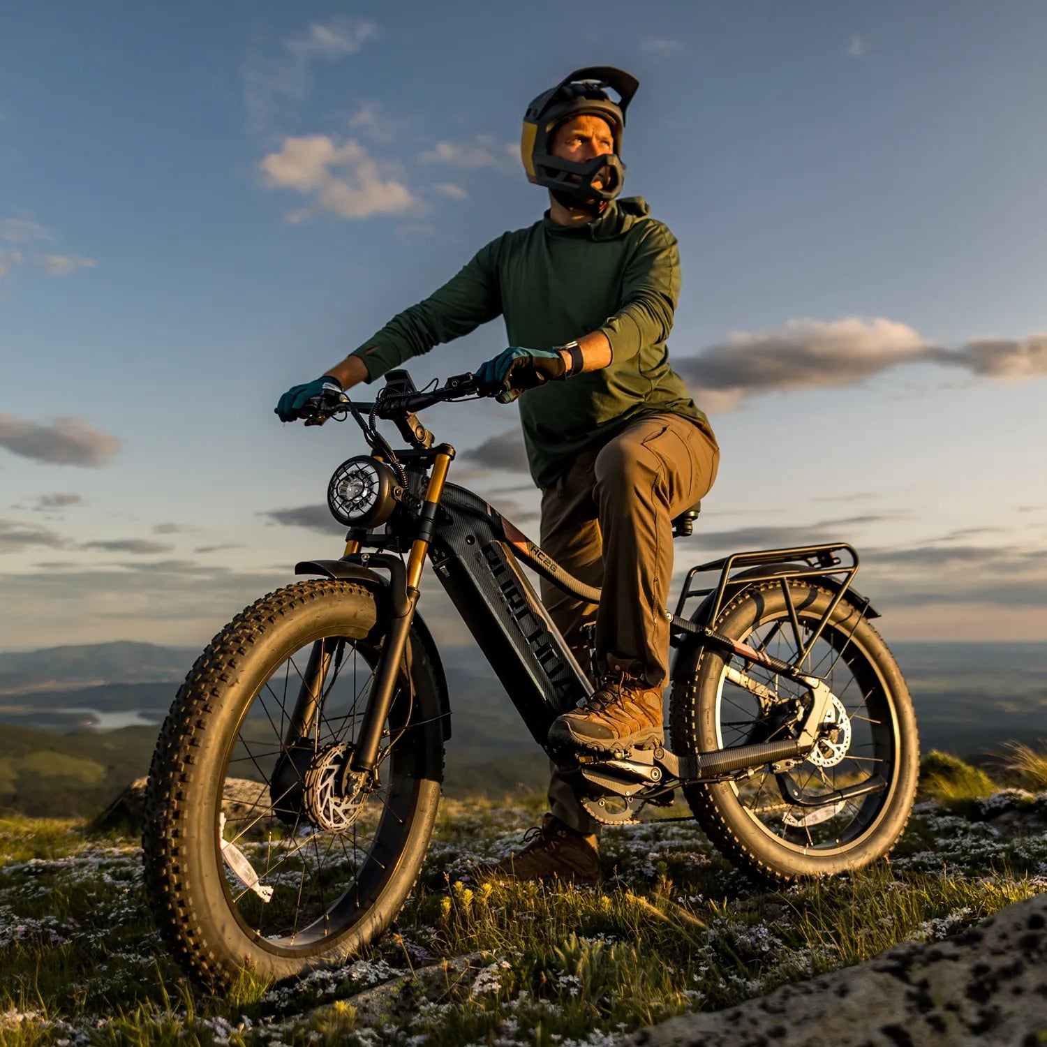 A man riding a BURCHDA HC26 AWD on a steep and rugged mountain trail