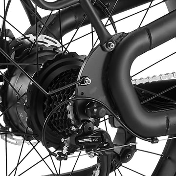 Close-up of the Burchda C35 rear hub motor with Shimano Tourney derailleur and 7-speed freewheel