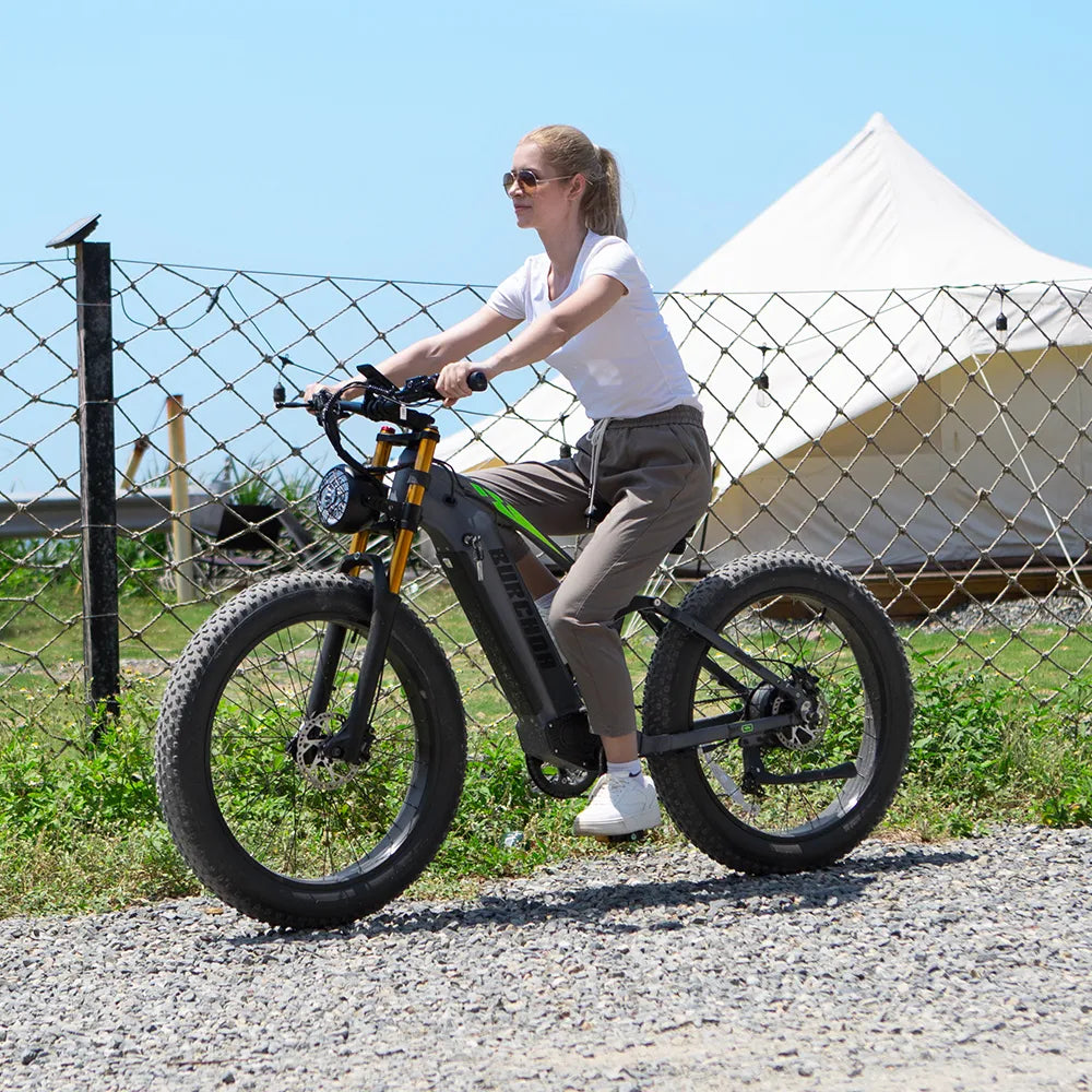 A woman riding a Burchda RX80 electric mountain bike